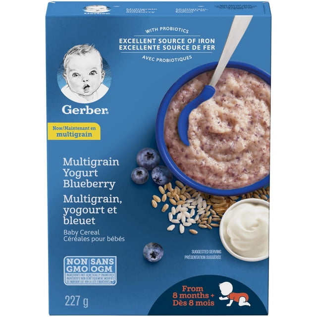 GERBER® Stage 3 Multigrain Yogurt Blueberry Baby Cereal 227 g box featuring a blue bowl of creamy multigrain blueberry yogurt cereal with a spoon, fresh blueberries, assorted grains, and a small dish of yogurt on a blue background, highlighting probiotics and iron for babies 8 months and older.
