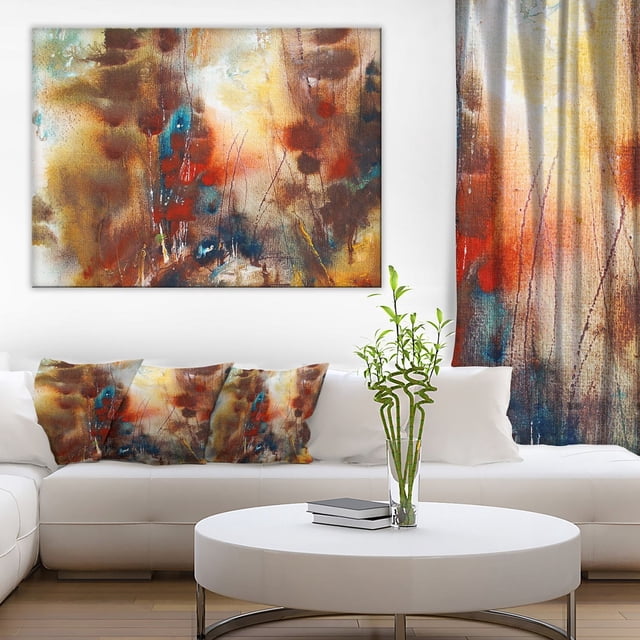 Design Art Artistic Brown Canvas Print with abstract brown, orange, blue, and beige tones on gallery-wrapped cotton canvas with a 1-inch wood frame, displayed above a white sectional sofa with matching abstract pillows and a white round coffee table holding a glass vase with green bamboo stalks, ideal for modern home décor.