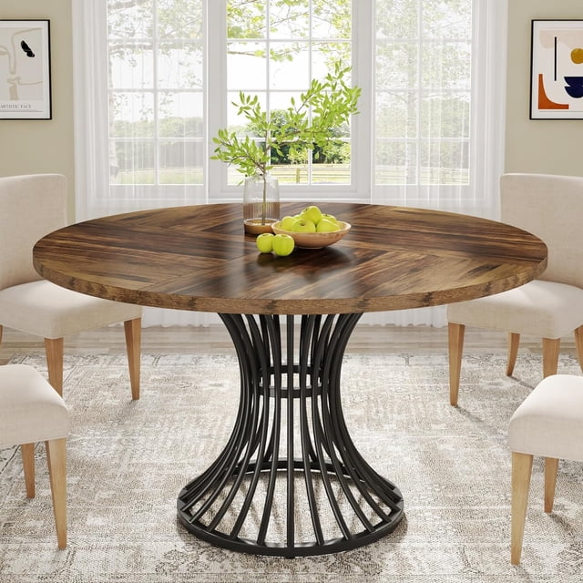 Tribesigns Round Dining Table for 4-6 People, a 47-inch farmhouse-style table with a rustic brown MDF top and an industrial hourglass-shaped metal base. Perfect for kitchens, living rooms, or dining spaces, it is shown in a bright room with beige chairs and a decorative centerpiece.