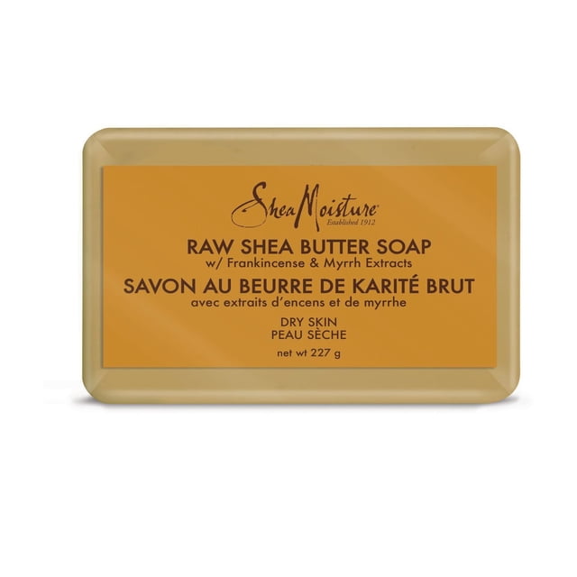 Shea Moisture Raw Shea Butter Soap bar for dry skin with frankincense and myrrh extracts, rectangular beige bar with an orange bilingual label in English and French, weighing 227 grams, suitable for daily moisturizing and gentle cleansing.