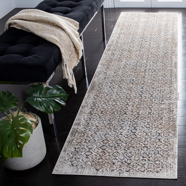 Safavieh Mayflower Hieren Geometric Area Rug 2'2"x9' runner with distressed vintage geometric pattern in soft neutral tones and subtle textured pile, power-loomed synthetic yarns for durability, placed on dark hardwood floor beside a black tufted bench with beige throw and potted green plant, suitable for hallways or entryways.