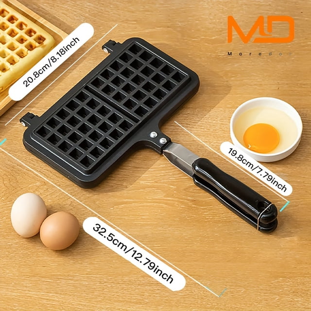 1pc Mini Waffle Maker Machine with a double-headed rectangular design, crafted from durable nonstick aluminum alloy. This compact, portable, non-electric waffle pan is displayed on a wooden countertop with eggs and a bowl of yolk, perfect for making waffles, pancakes, and paninis at home or outdoors.