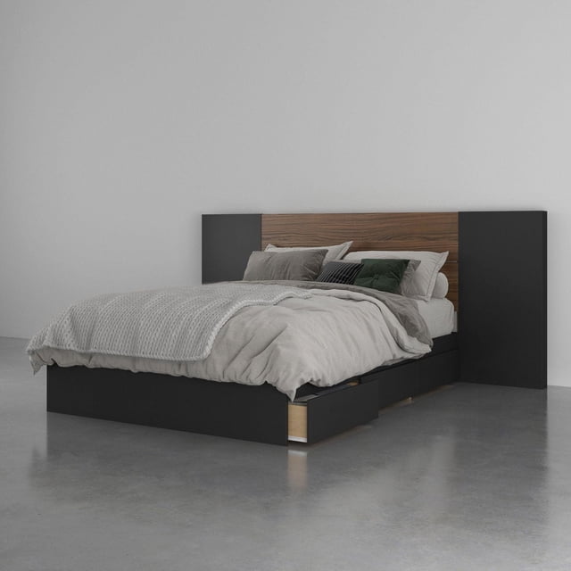Onyx 3 Piece Bedroom Set, Walnut and Black with a storage bed featuring three drawers on metal slides beneath, a rustic walnut plank headboard with black side panels, displayed in a minimalist setting with neutral bedding and polished concrete floor, suitable for maximizing bedroom storage.