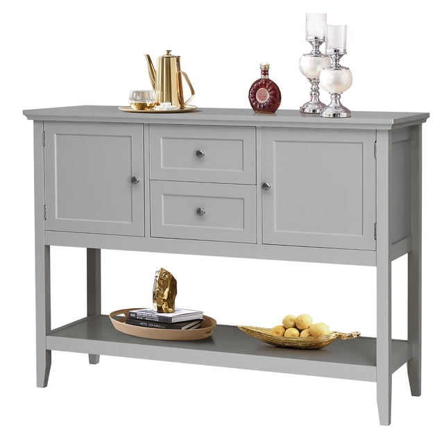 Costway Sideboard Buffet Table Wooden Console Table w/ Drawers & Cabinets Gray. This gray console table features a sturdy MDF and pine wood construction with a weight capacity of 220 lbs. It includes two cabinets, two drawers, a spacious top surface, and a bottom open shelf for ample storage and display. The table is accented with metal knobs and tapered legs, offering a stylish and elegant design suitable for living rooms, kitchens, hallways, or offices. Decorative items such as candles, books, and fruit bowls are displayed on the table and shelf.