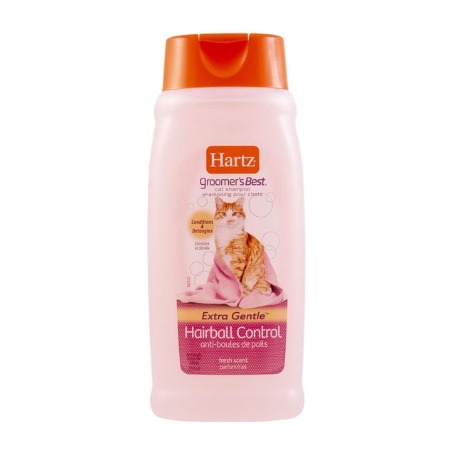 Hartz Groomer's Best Hairball Control Shampoo for Cats in a pink 15 fl oz bottle with an orange flip-top cap, featuring an orange and white cat wrapped in a pink towel on the label, formulated to condition, detangle, and reduce hairballs with a fresh scent.