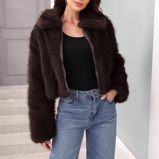 Mceream Women's Faux Fur Cropped Coat in coffee colour, featuring an open front design with a zip closure. This fluffy cardigan-style jacket has a shaggy texture and a short, cropped fit, perfect for plus-size winter outerwear. Suitable as a women's blazer for casual or dressy occasions, styled with jeans and a black top in a modern indoor setting.