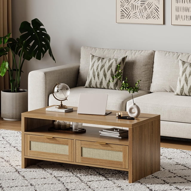 BeesClover 40” Boho Coffee Table with Storage in oak finish, featuring a modern rattan design with two drawers and an open shelf. The table is made of durable MDF board and is styled in a cozy living room setting with a beige sofa, decorative pillows, and a patterned rug. Ideal for small spaces, it offers ample storage for books, magazines, and decor items.