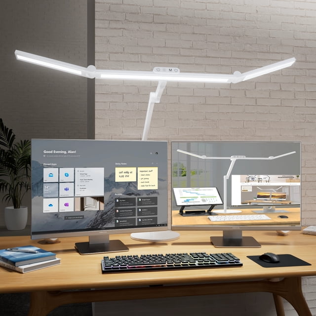 LED Desk Lamp for Home Office - 24W Architect Table Lamp with Long Swing Arm Corded Electric 1500LM Bright Dimmable Computer Table Light in white. The lamp features a rotatable design with 5 adjustable joints and bilateral light bars for customizable lighting angles. It includes 5 color temperature modes and 5 brightness levels, controlled via touch sensor or remote. The 8-inch heavy round base with anti-slip pads ensures stability on any desk. Shown in a modern home office setup with dual monitors and a wooden desk.