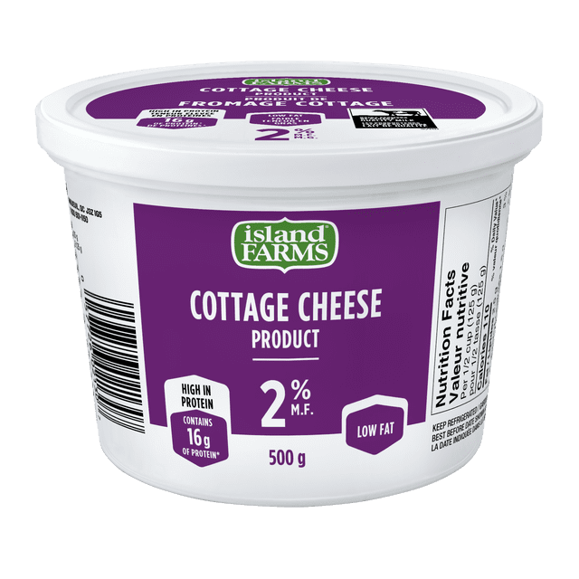 Island Farms Old Fashioned 2% Cottage Cheese in a 500 g white plastic tub with a purple label, featuring 16 g of protein and low fat content, nutrition facts visible on the side, made from fresh Canadian milk, often used as a versatile addition to fruits or baked potatoes.