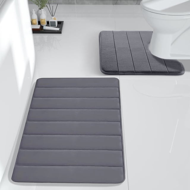 Sokhug Rugs Clearance Bathroom Rugs Sets 2 Foam Bath Mat for Toilet. This set includes two soft, absorbent bath rugs made of memory foam with a microfiber coral velvet surface in a grey color. The mats feature a non-slip rubber backing for safety and are machine washable for easy care. Suitable for bathroom floors, these mats are designed to quickly absorb water and provide comfort underfoot.