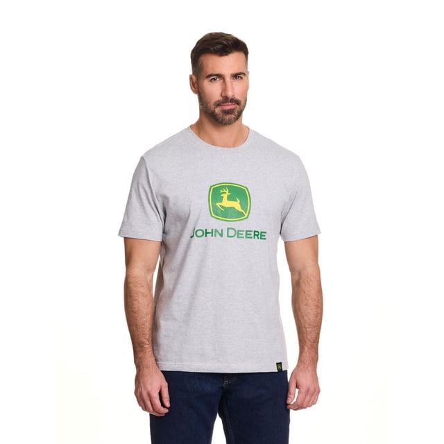 John Deere Men’s Logo Graphic Short Sleeve Tee in grey jersey fabric with the green and yellow John Deere core logo screen printed on the chest, shown in a front-facing view paired with dark blue jeans, ideal for casual or outdoor wear.