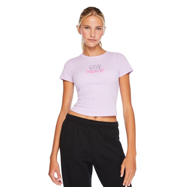 No Boundaries Women's Rib Baby Tee in light purple rib knit fabric with a crew neckline, short sleeves, and a curved hem, featuring a small graphic of two cats and pink text on the chest, styled with black elastic waist pants in a front-facing view.