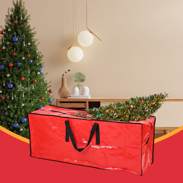 Wzzjkit Christmas Tree Storage Bag in a vibrant red color with reinforced black handles and a zippered closure, shown partially filled with a disassembled artificial Christmas tree. The bag measures 122x50x38cm (48.03x19.68x14.96in) and is made of durable, waterproof PE material. It is designed to protect and organize holiday decorations, keeping them safe from dust and damage during storage. The background features a decorated Christmas tree and a modern interior setting.