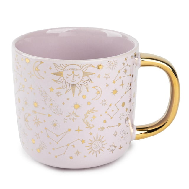 Thyme & Table Stoneware Coffee Mug, 16 fl oz, Gold Stars with a light pink ceramic body decorated with gold celestial designs including suns, moons, stars, and constellations, featuring a polished gold handle, freezer and dishwasher safe, suitable for everyday coffee or tea and often used as a decorative kitchen accent.