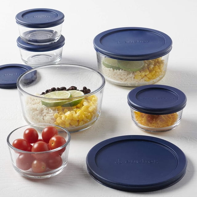 Anchor Hocking 12pc Food Storage Set w/Navy Snugfit Lids with clear glass containers in 1-cup and 4-cup sizes featuring navy blue lids, some filled with rice, corn, black beans, cherry tomatoes, and lime slices, suitable for microwave, oven, fridge, freezer, and dishwasher use, ideal for organized kitchen food storage and meal prep.