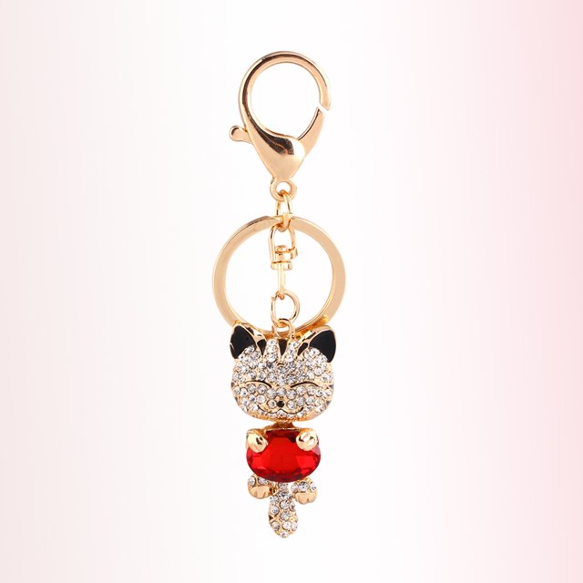 Keychain, Pendant Purse Bag Key Chain Key Holder with a 3D rhinestone cat design featuring black ears and a red gemstone body. Made of alloy and rhinestones, it includes a gold-tone clasp and ring, suitable as a decorative keyring, car key chain, or travel accessory. Perfect gift for kids and girls.