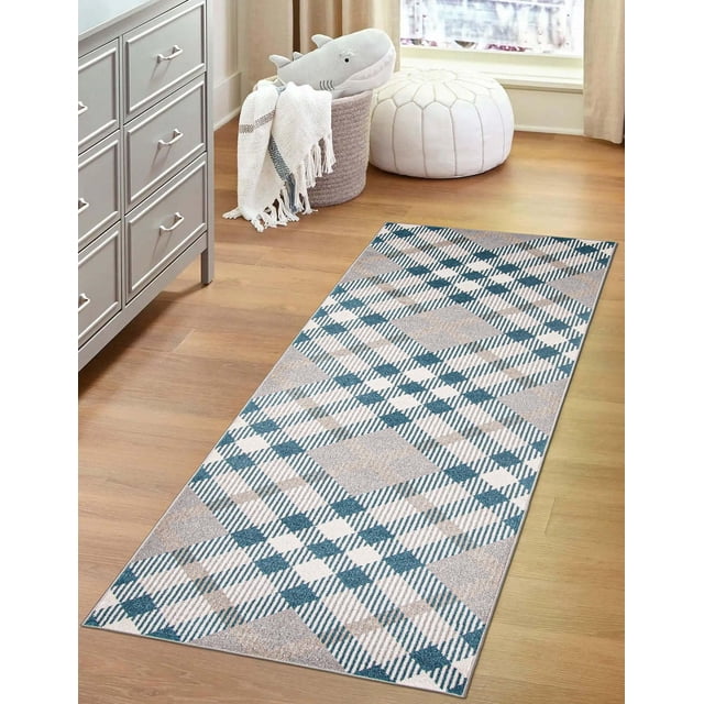 ECARPET washable plaid area rug and runner in grey with aqua and white geometric plaid pattern on low pile polyester, placed on light wood floor beside a grey dresser, near a white pouf and a basket holding a shark plush toy and fringed throw blanket, ideal for kitchen, bedside, living room, or hallway and suitable for high traffic areas.