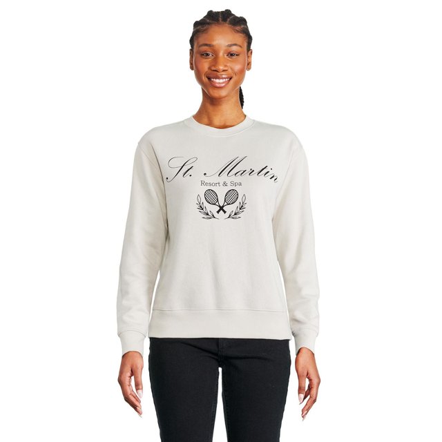 St. Martin Resort & Spa women's off-white crewneck sweatshirt with black printed crossed tennis rackets and laurel leaves logo, ribbed cuffs and hem, shown in a front-facing view paired with black pants.