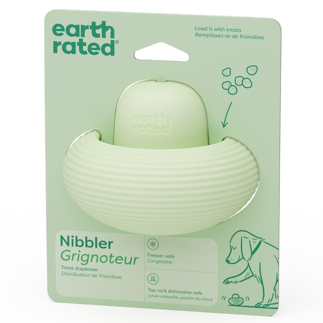 Earth Rated Nibbler Dog Toy, a pale green ribbed natural rubber treat dispenser that slowly releases treats as dogs play, shown in retail packaging with freezer-safe and dishwasher-safe icons and a dog illustration.