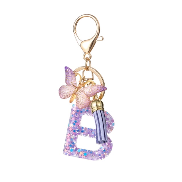 UsTZtai Fashion 26-Letter Key Chain Pendant with a glittery resin letter 'B,' a purple butterfly, and a lavender tassel. The gold-tone key ring features an easy-to-use clasp, ideal for multi-functional use such as attaching to backpacks, home keys, car keys, or travel accessories.