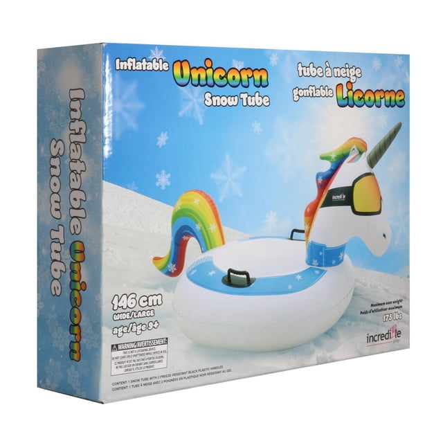 INCREDIBLE GROUP UNICORN SNOW SLED inflatable 146 cm wide snow tube shaped like a white unicorn with rainbow mane and tail, featuring two black freeze-resistant plastic handles, suitable for ages 9 and up, shown on snowy ground with blue sky on packaging