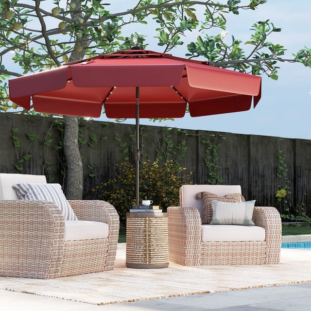 Costway 10 FT Solar Patio Umbrella with 32 LED Lights in red, featuring a 3-tier vented top and ruffled edges for enhanced airflow and sunshade. The umbrella is shown in an outdoor setting with wicker chairs and a side table, providing shade and ambiance. Equipped with solar-powered LED lights along the ribs for nighttime illumination, a push-button tilt for adjustable shade, and a crank handle for easy operation. Made of durable polyester fabric, it offers sun protection and weather resistance.