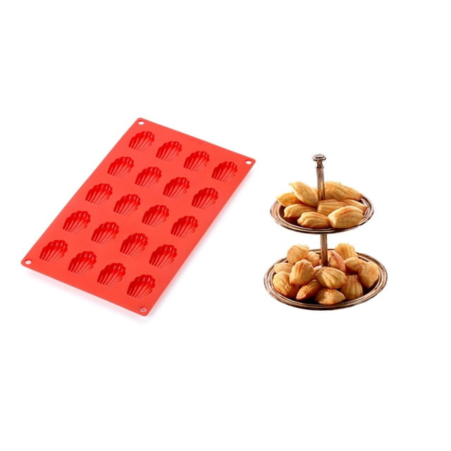 Lekue Red Mini Madeleines Mould made of flexible silicone with 24 shell-shaped cavities, shown alongside a two-tiered silver serving tray filled with golden-brown madeleine cookies, designed for non-stick easy release and professional home baking results, also suitable for savoury dishes.