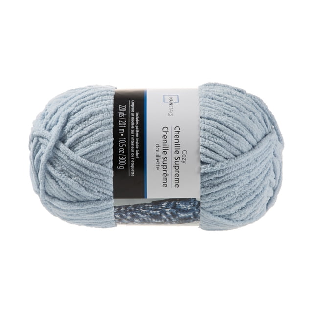 Mainstays Cozy Supreme Chenille Yarn Niagara Mist in a centered front view, showing a soft light blue chenille yarn skein with a label indicating 220 yards and 10.5 ounces, suitable for knitting, crafting, and ideal for blankets with included pattern instructions.