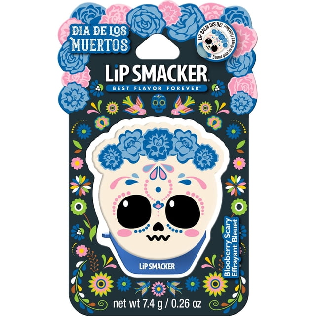Day of the Dead Flip Balm by Lip Smacker featuring a sugar skull with blue floral crown and pink and blue decorative face details on black packaging decorated with colorful flowers and birds, flavored Blooberry Scary, net weight 7.4 g / 0.26 oz, suitable as a kids' beauty gift set item.