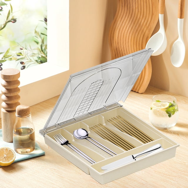 Dvkptbk Polycarbonate Storage Cutlery Organizer with lid, featuring a white plastic design and five compartments for categorizing utensils. The organizer is shown on a tabletop with cutlery neatly arranged inside, and a transparent lid partially open. Suitable for kitchen drawer organization, tabletop use, and outdoor picnics.