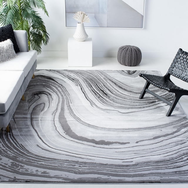 SAFAVIEH Craft Floella abstract area rug featuring swirling gray and white patterns in a contemporary living room.