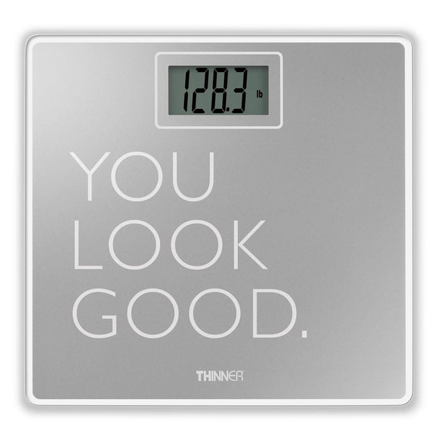 Thinner by Conair Digital Glass Phrase Scale with a metallic silver tempered glass platform displaying a digital weight of 128.3 lb on a large LCD screen, featuring the phrase 'YOU LOOK GOOD.' in white text on the surface.