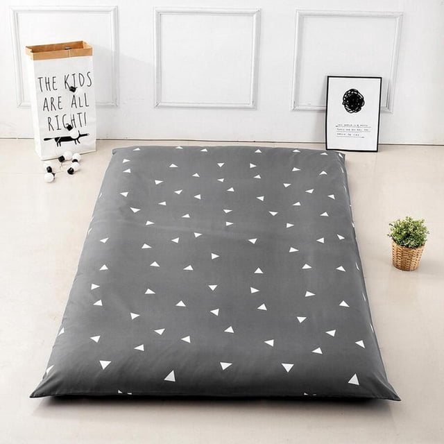 Traditional Japanese floor futon mattress protection cover in a grey fabric with white triangle patterns, shown in a minimalist room setting. Available in sizes 35x79 inches and 47x79 inches, made of durable polyester fiber material. This tatami mat cover protects against dust and dirt and is easy to clean and maintain.