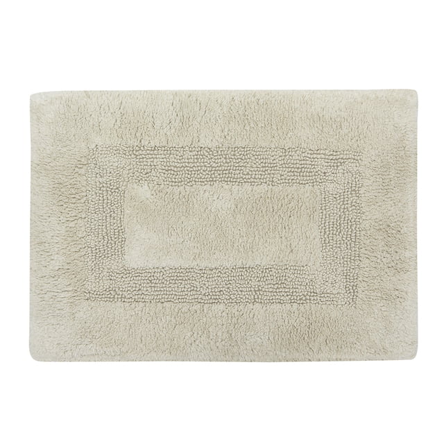 Mainstays Racetrack 100% Cotton Oak Bath Rug, 17" x 24", rectangular beige bath rug with a textured racetrack pattern featuring a plush center and border, made from 100% BCI cotton with non-slip backing, machine washable and suitable for bathroom floors, also often used as a cozy mat for entryways.