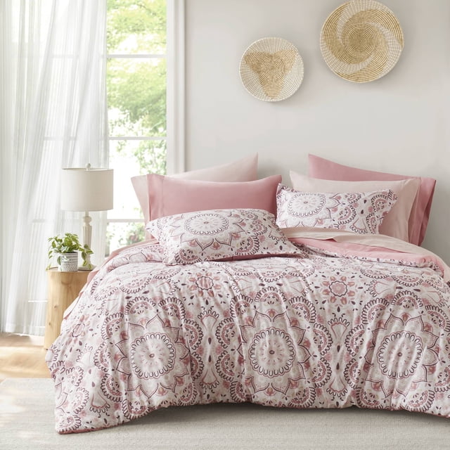 Regency Heights Full Size Comforter Set, 9-Piece Bed in a Bag Full, featuring a pink medallion pattern. The set includes a comforter, flat sheet, fitted sheet with side pockets, two shams, and four pillowcases. Made from ultra-soft microfiber, it is lightweight, breathable, and Oeko-Tex certified for safety. Displayed in a bright bedroom with natural light, the bedding adds a stylish and cozy touch to the decor.