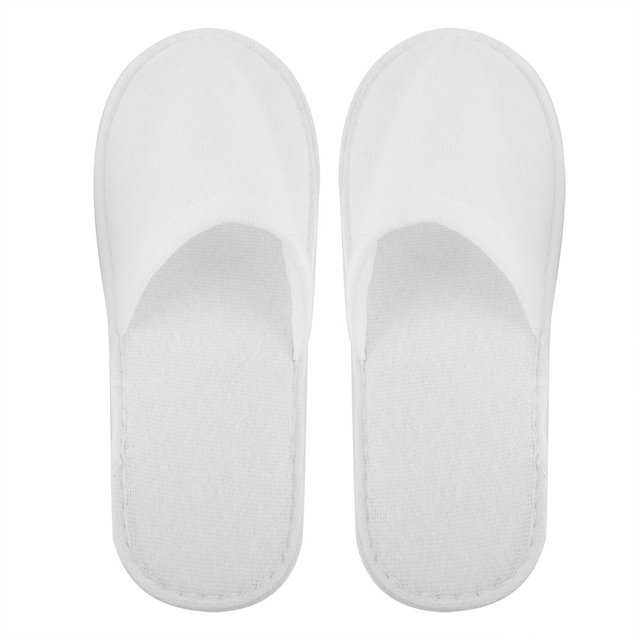 Spa Slippers, 10 Pairs Hotel Travel Slippers Disposable Slippers Future-Proof Design. A pair of white disposable slippers made of high-quality fleece material, featuring a soft and cozy texture. The slippers have an anti-slip textured sole and are designed for comfort, even for extra wide feet. Ideal for use in spas, hotels, or for home guests. Each set includes 10 pairs, with a total length of approximately 28 cm (11 inches).