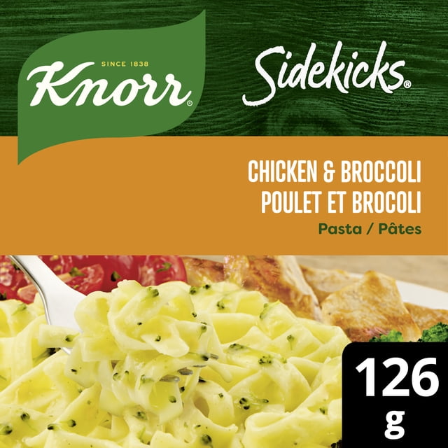 Knorr Sidekicks Chicken & Broccoli Pasta Side Dish showing creamy fettuccine pasta with broccoli in a chicken sauce on a fork, with a plate of food in the background and a 126 g serving size label, suitable for quick and easy pasta side meals.