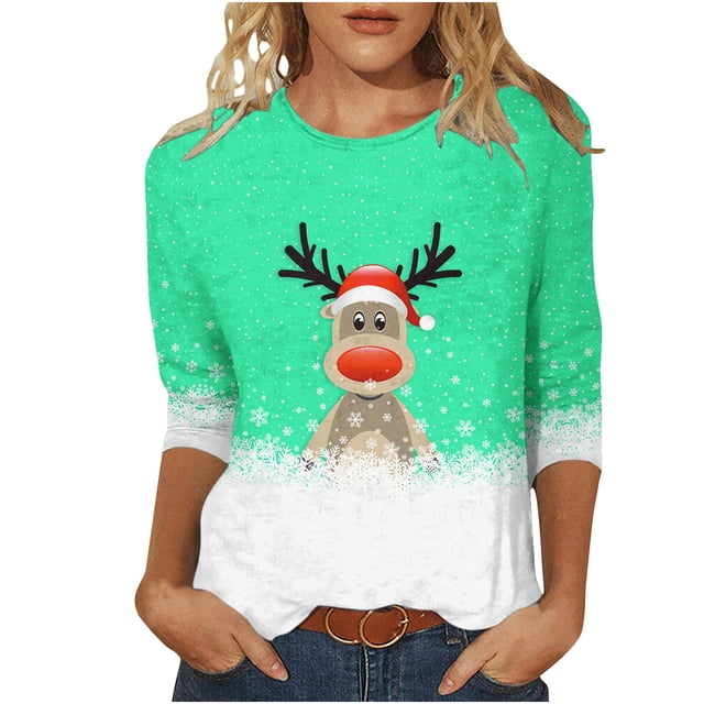 Women's Round Neck Three Quarter Sleeve Christmas Printed Top featuring a festive reindeer design with a Santa hat on a green background with white snowflake accents. Made from lightweight polyester, this casual top is styled with a round neckline and three-quarter sleeves. Suitable for daily wear, parties, or holiday events. Available in sizes S to XXXL.