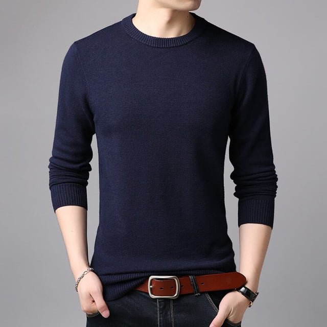OmicGot Men's Sweaters Pure Color Slim Young Sweater Round Collar Big Size Pullover for Man Tops Thin Sweater. A casual, slim-fit men's pullover sweater in solid navy blue, featuring a round O-neck collar and long sleeves. Made from a cotton and polyester blend with computer-knitted construction, this lightweight sweater is suitable for autumn and designed for youth. Shown styled with jeans and a brown belt.