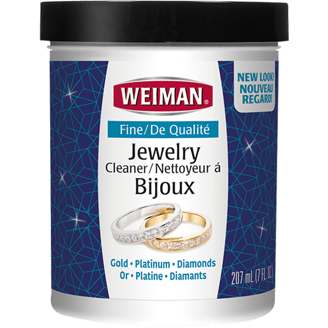 Weiman Fine Jewelry Cleaner for Gold, White Gold, and Precious Stones in a 7oz container with a black lid, featuring gold and diamond rings on the label and a blue geometric background, designed to gently clean and protect fine jewellery including gold, platinum, and diamonds while restoring sparkle.