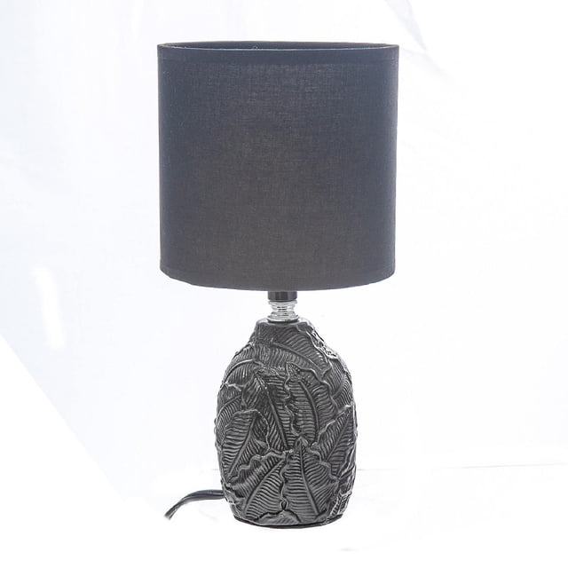 Ceramic Table Lamp With Shade Leaflet Black featuring a black ceramic base embossed with leaf patterns and a cylindrical black fabric shade, measuring 6 by 6 by 12.6 inches, suitable as a stylish bedside or living room accent.