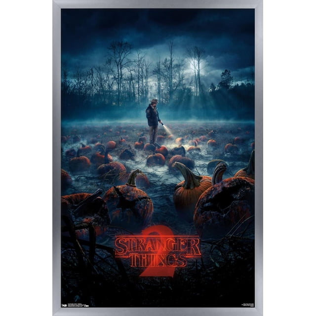 Netflix Stranger Things: Season 2 - Pumpkins Wall Poster, 22.375" x 34" depicts a foggy nighttime pumpkin patch with decayed pumpkins and a man in a hat and jacket shining a flashlight, bare trees under a cloudy sky, and the red glowing Stranger Things 2 logo, suitable for spooky home décor.