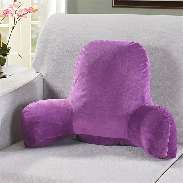 Mefallenssiah Plush Big Backrest Reading Pillow Lumbar Support Chair Cushion with Arms in a vibrant purple color, crafted from plush material with pp cotton filling. This reading pillow features a tall backrest and arm supports, ideal for lumbar support while reading or relaxing. It is placed on a light grey sofa in a cozy, well-lit room with floral accents.