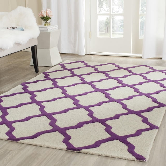 Safavieh Cambridge Liam area rug featuring a white base with an interlocking purple geometric trellis design on light wood flooring.