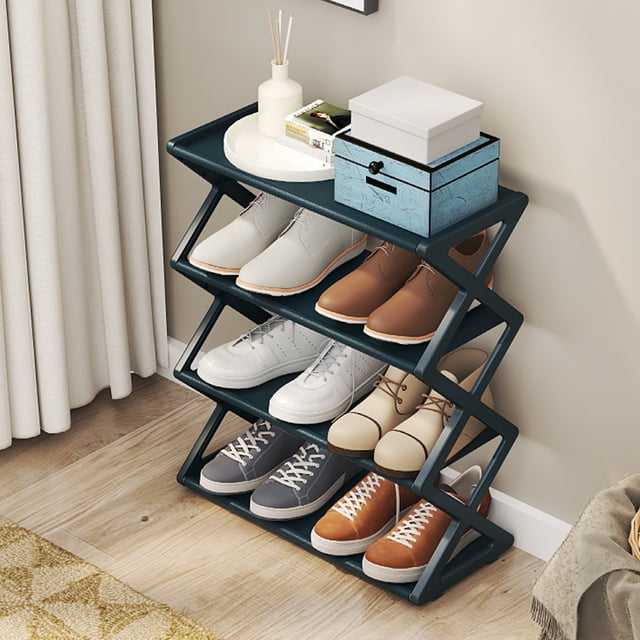 Clearance Savings Hot6sl Home Storage Organiser, Kitchen Goodies, Household X-type Shoe Rack Multifunctional Double Steel Tube Assembly Shoe Cabinet Dormitory Shelf in black. This modern shoe storage solution features an X-shaped frame with four tiers, each accommodating multiple pairs of shoes. Designed for space-saving organization, the rack is shown in a home setting with shoes neatly arranged and decorative items like boxes and vases on the top shelf.