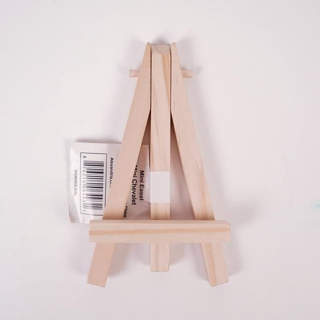 North Shore's wooden mini easel made of light natural wood with a collapsible base, shown front-facing on a white background, designed to hold small canvases or artboards, folds flat for storage, suitable for artists with limited space and often used for displaying mini canvases.