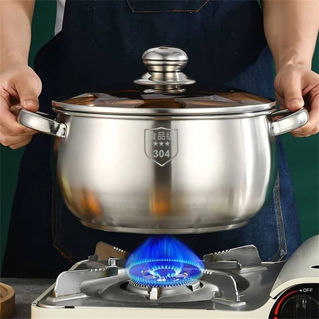 xaoyunyn stainless steel double handle soup pot with a 24CM diameter, shown being held above a gas stove with blue flames. The pot features a thick base for even heating, a big belly design for ample capacity, and double handles for easy maneuverability. Ideal for family gatherings and versatile cooking methods like boiling, stewing, and steaming. A durable stockpot suitable for various heat sources, including induction cookers and gas stoves.