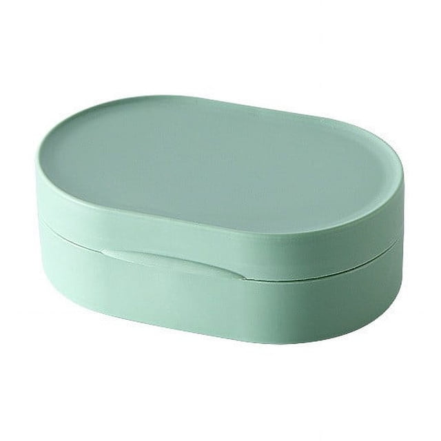 EGNMCR Travel Soap Box With Lid Mini Portable Soap Box made of silicone, shown in a compact oval shape with a tight-sealing lid in a light green color. Designed for travel and outdoor use, it prevents leaks and keeps soap dry. The sleek design is versatile for storing small items like jewelry or earphones.