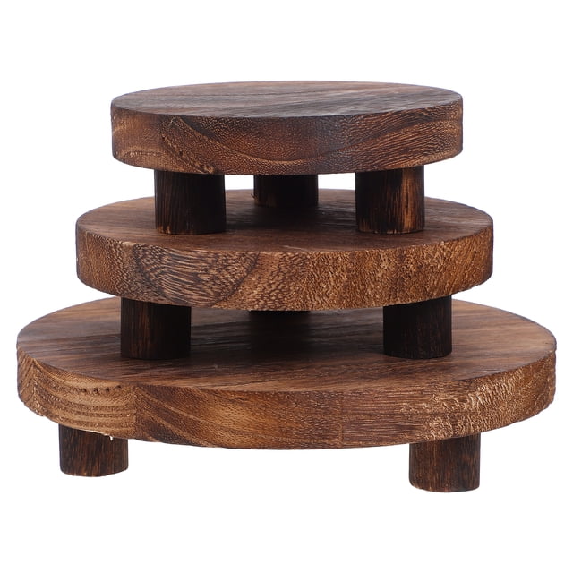 Shisuyan 3pcs wood plant stand set featuring round wooden risers in coffee color. Includes three sizes: 12.50cm, 15.00cm, and 19.70cm diameter, each with a height of 4.00cm. Designed for succulents and orchids, these rustic pedestals showcase hand-polished craftsmanship and stackable functionality for easy storage. Ideal as a plant display stand for home or office decor.