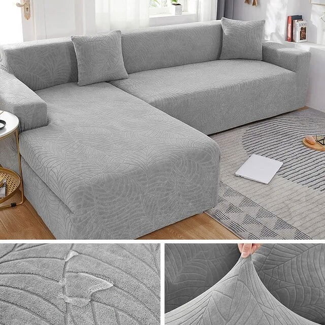 Waterproof Sofa Covers 1/2/3/4 Seats Jacquard Solid Couch Cover L Shaped Sofa Cover Protector Bench Covers in light grey with a textured jacquard pattern. The stretchable, waterproof fabric ensures a snug fit and non-slip design, ideal for protecting sofas from spills, stains, and wear. Suitable for various sofa sizes and shapes, including L-shaped configurations. Displayed in a modern living room with neutral decor.